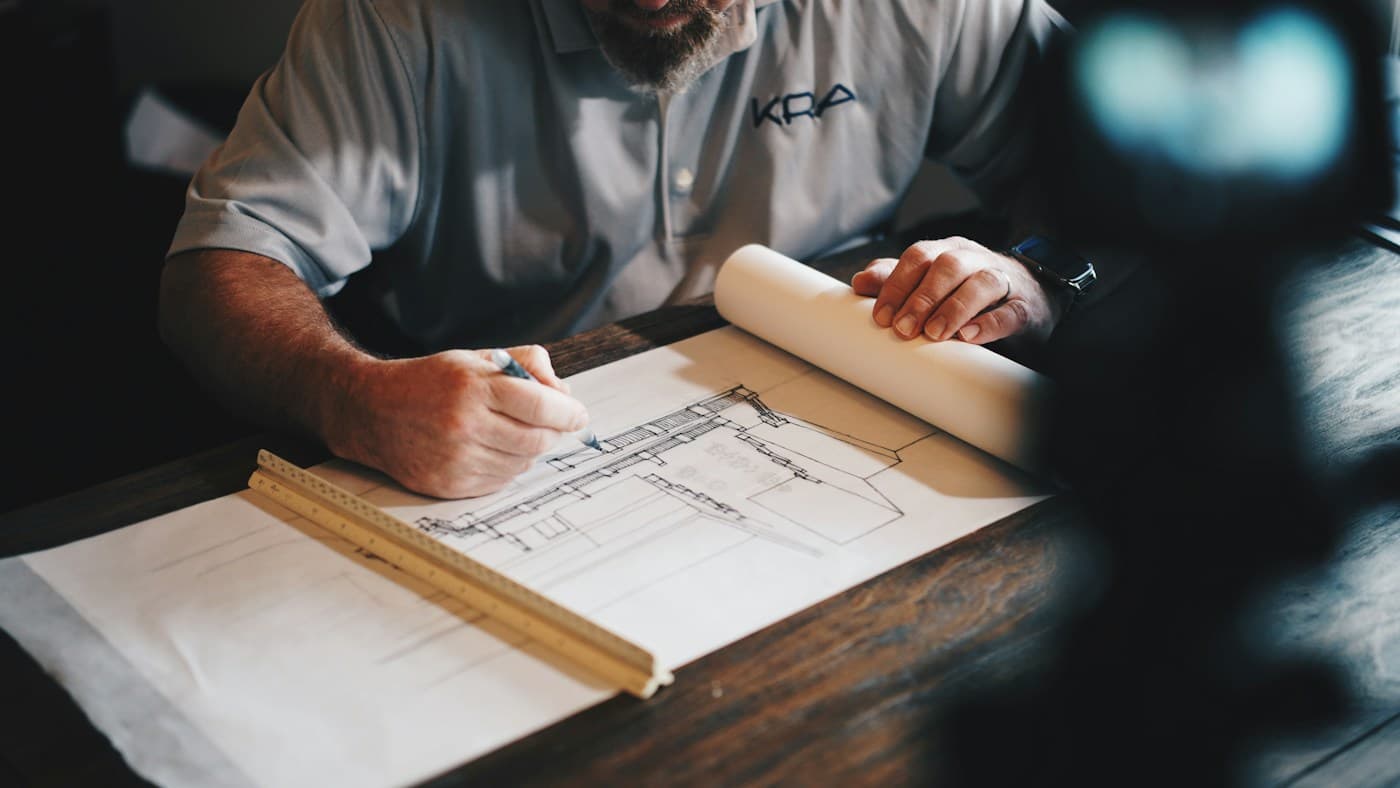 Construction professional working on architectural plans